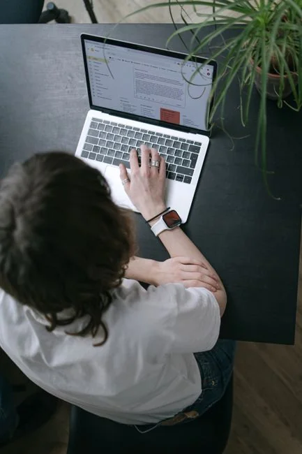Two colleagues collaborate on a marketing strategy using a whiteboard, focusing on user-generated content.